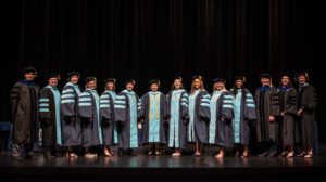 Doctoral candidates and faculty pose following the College of Education Graduate School Commencement