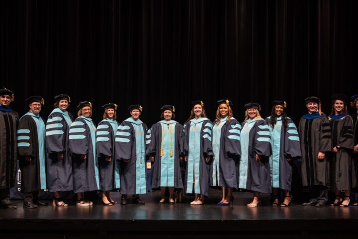 Doctoral candidates and faculty pose following the College of Education Graduate School Commencement