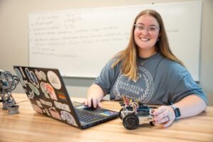 A woman working on her robot- Engineering Testimonial