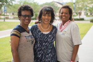 Three alumni reuniting at homecoming