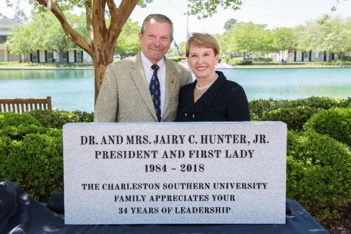 Dr. and Mrs. Hunter poses behind dedicated 34 years of leadership engraving