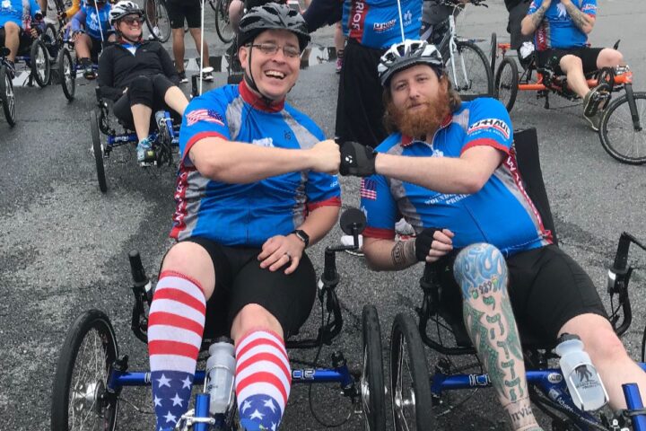 Matthew Shelton fist bumps after a bike race