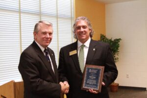 Daniel Inabinet shakes hand with Jairy C. Hunter