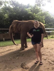 Deanna Yates smiles in front of elephant