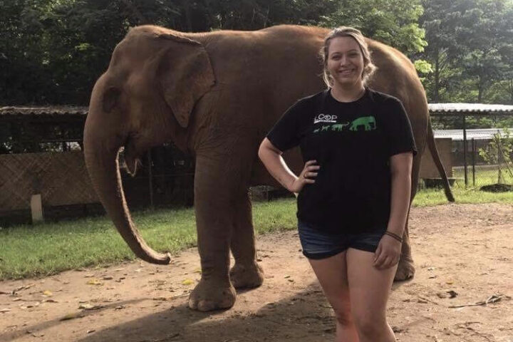 Deanna Yates smiles in front of elephant