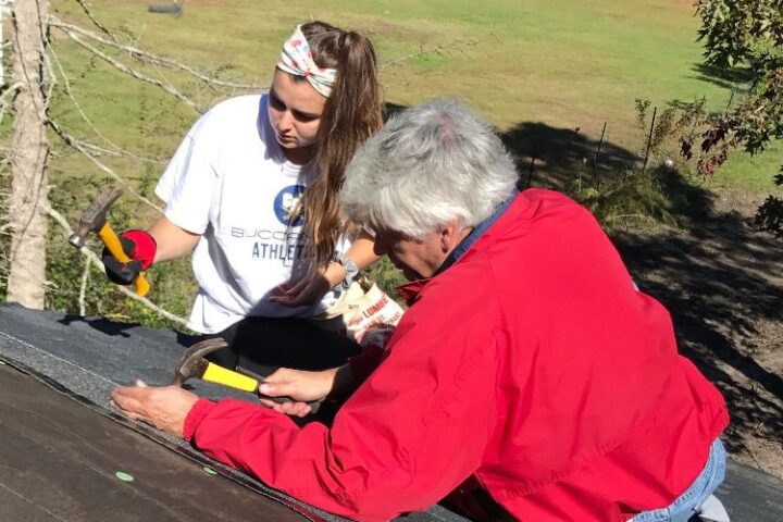 Maxwell Rollins with a student at a Habitat build day in fall 2018.