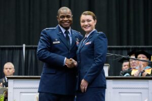 AFROTC cadet shaking hand with Commander Roosevelt Loveless