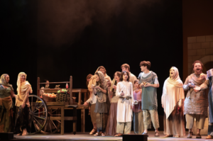 Many people performing a play on stage