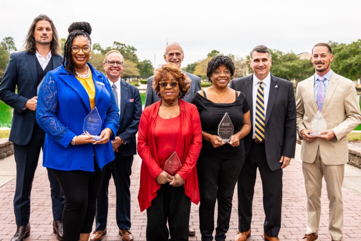 Alumni's group received an award, with the point in the background
