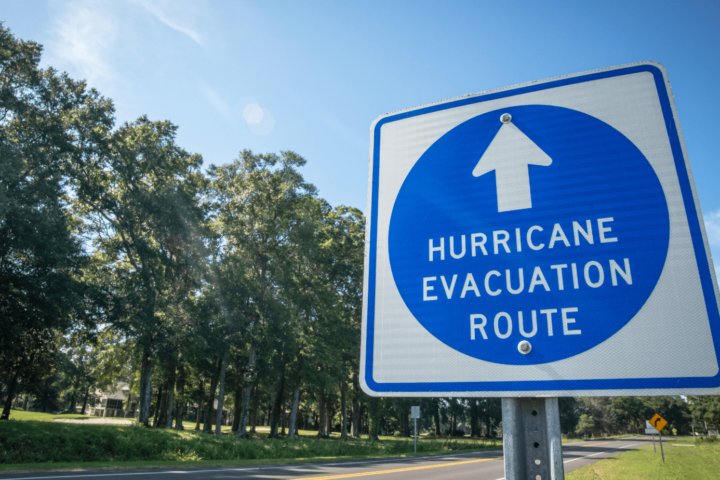 A board sign saying hurricane evacuation route