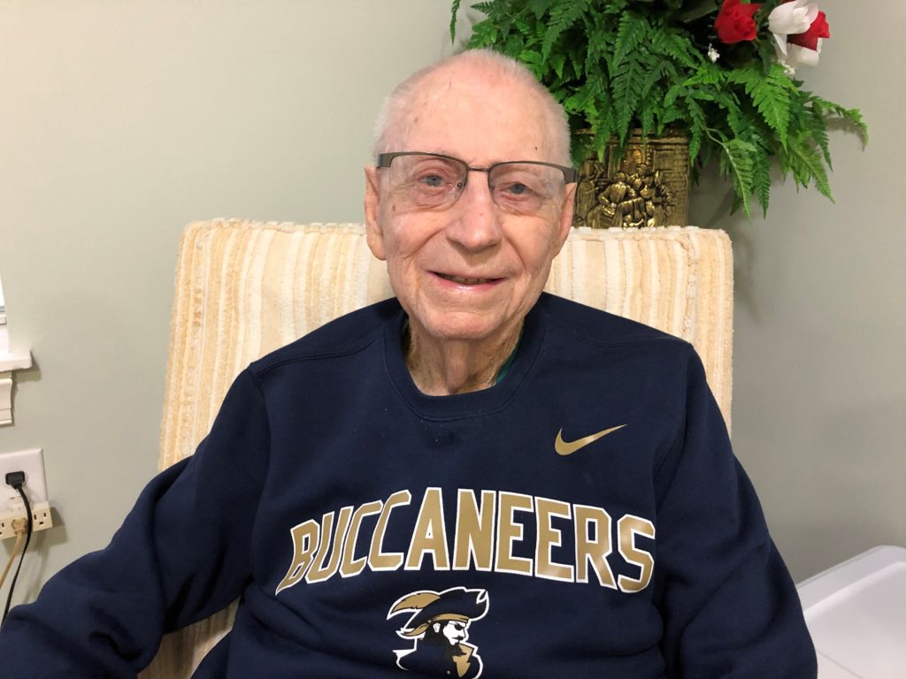 Ken Swain wearing a blue Buccaneer sweater