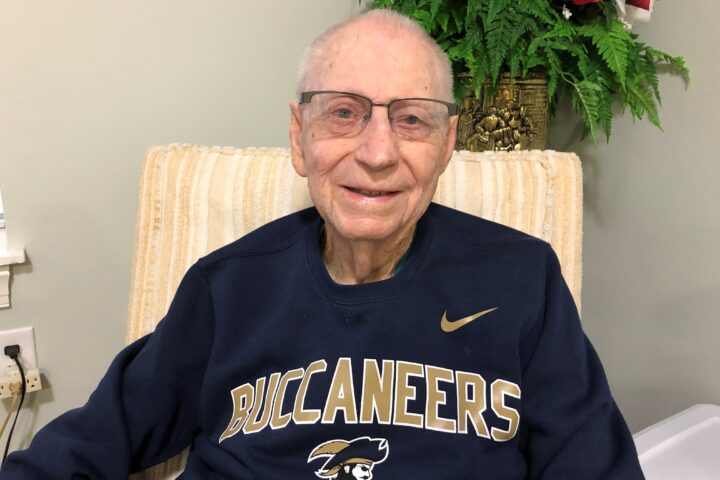 Ken Swain wearing a blue Buccaneer sweater