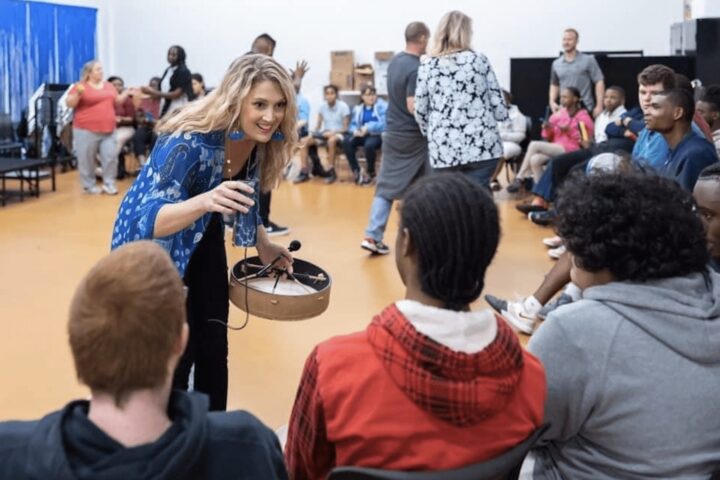 CSU alum Catherine Nielsen leads a drum circle for students of all abilities in a school setting.