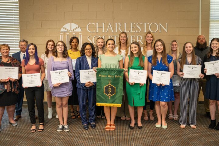 Multiple people earning their sigma Beta Delta diploma