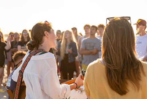 Large group of CSU students talk in a circle outside