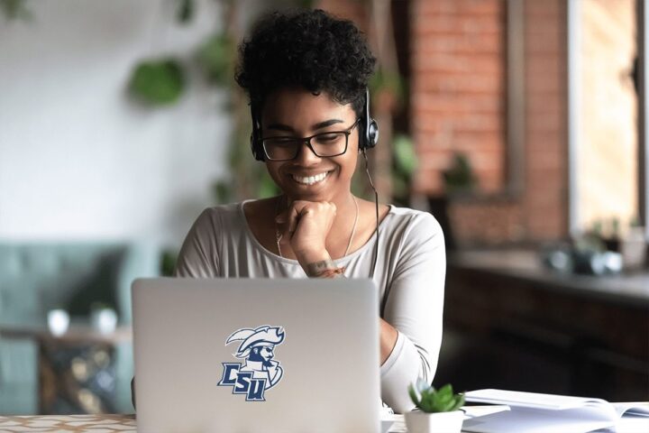 Online student wearing headphones while on a laptop computer