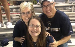 Cliff Marshall poses with his wife Sherry and daughter Grace at a CSU football game.