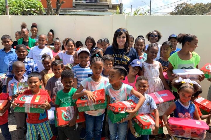 Lauriel Diel with children who received show boxes from CSU's Operation Christmas Child.